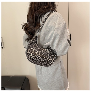 Chic leopard print crescent shoulder bag styled as a trendy underarm bag for women