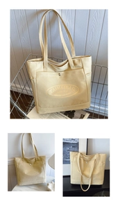 Detail view of beige canvas tote bag with front pocket and TAIMEIBAG branding text
