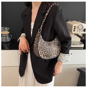 Leopard print hobo shoulder bag with a sleek crescent design and gold metal hardware