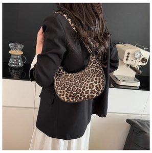 Detailed view of fashionable leopard print crescent hobo bag styled with a casual outfit