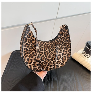 Close-up of leopard print crescent moon shoulder bag with black trim and zipper detail