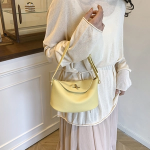 Chic yellow lychee leather bucket bag for women with golden twist lock for daily style