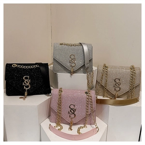 Detailed display of sparkly crossbody bags in black, silver, gold, and pink colors