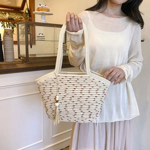 Minimalist woven straw tote bag with brown textures and tassel charm for summer