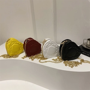 Chic quilted heart-shaped mini chain bags in yellow, burgundy, white, and black colors