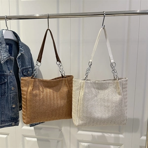 Chic woven straw tote bag in brown and beige with chain strap for casual daily commuting