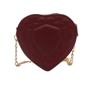 Burgundy heart-shaped crossbody bag with quilted diamond pattern and gold chain strap