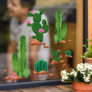 Close-up of five cactus window stickers with pink flowers on a clear glass pane