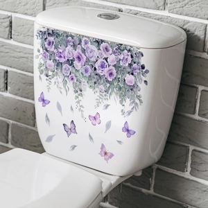 Detail of waterproof purple rose and butterfly self-adhesive decals on a white ceramic toilet