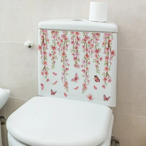 Detailed view of pink floral and butterfly waterproof stickers on a white ceramic toilet tank