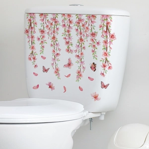 Detail of floral toilet stickers featuring pink cherry blossoms and colorful butterflies