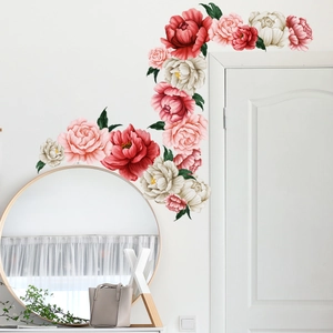 Vivid red and pink peony wall decals surrounding a white door in a cozy room