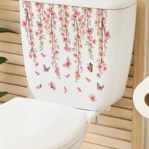 Detailed view of pink cherry blossom wall stickers with butterflies on a white toilet tank