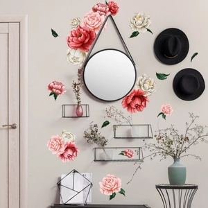 Detailed view of red peony floral wall stickers decorating a cozy living room wall