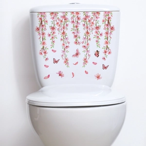 Detail of pink floral toilet tank sticker with butterflies on white ceramic surface