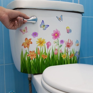 Floral and butterfly self-adhesive decals applied on a white toilet tank surface