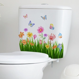 Vibrant floral and butterfly decals applied to a white ceramic bathroom toilet tank