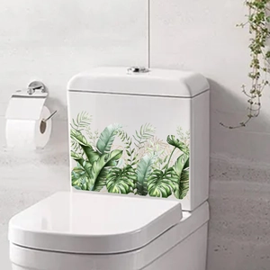 Detailed view of tropical monstera leaf wall stickers with gold outlines on bathroom ceramic