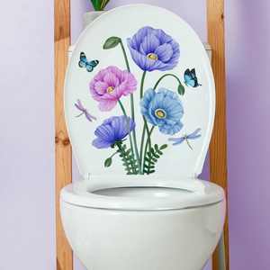 Detail of floral toilet seat decals with blue poppies and butterflies in bathroom