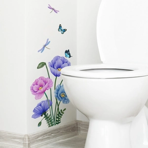 Detail of colorful floral and butterfly wall stickers on a white bathroom surface