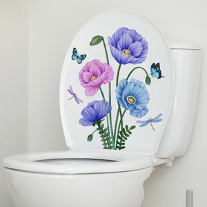 Detailed view of floral toilet lid stickers with purple poppies and blue butterflies