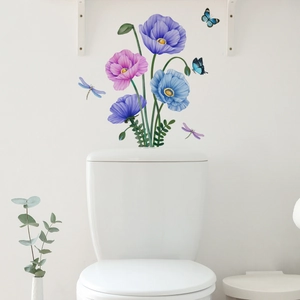 Detail showing watercolor flower stickers and blue butterflies on a white bathroom wall