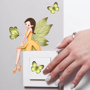 Detailed close-up of luminous fairy and butterfly wall stickers on a square white light switch