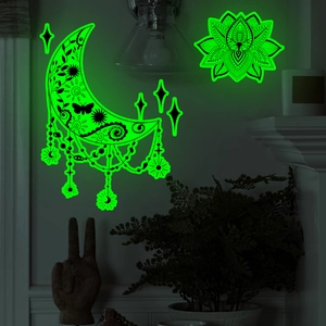 Luminous moon and lotus mandala wall stickers glowing green in a dark room setting