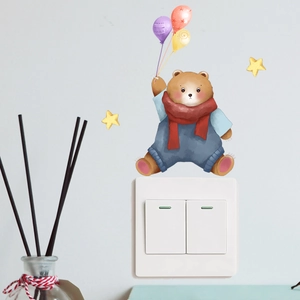 Detailed view of cartoon bear and balloons wall sticker applied on a white light switch