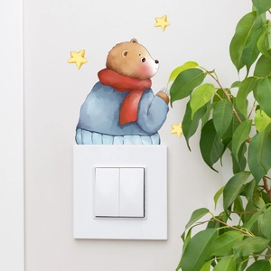 Detail of cartoon bear and yellow stars luminous light switch wall sticker on white wall