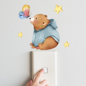 Detailed view of luminous bear and stars wall sticker on white light switch