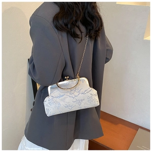 Classic Chinese brocade crossbody bag with blue landscape pattern and golden handle