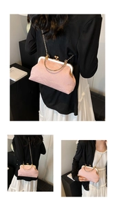 Detailed view of pink marble textured fabric and gold metal clasp on retro evening bag