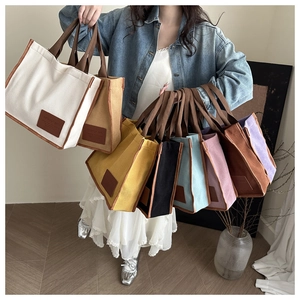 Detailed display of colorful canvas tote bags with premium fashion leather labels