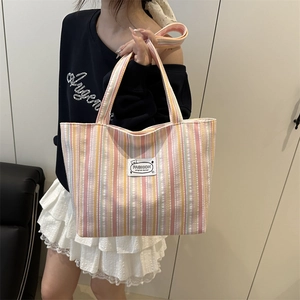Colorful striped canvas tote bag with multi-functional handles and fashion label design