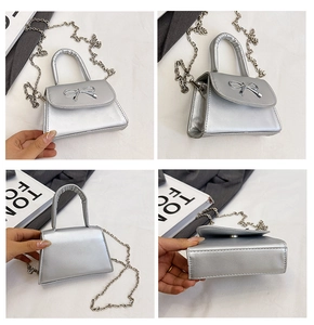 Détails d'un sac à main argenté avec noeud, montrant la texture et la chaîne métal