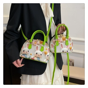 Detail of floral tote bag showing 3D crochet rabbit and colorful flower patterns