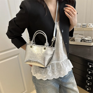 Chic silver mini tote bag with wrinkled metallic texture and adjustable shoulder strap