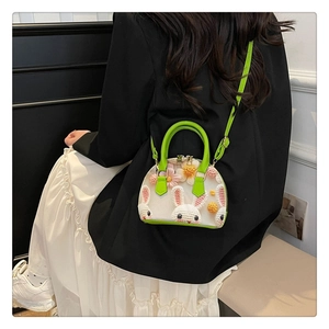 Detail of floral shell bag with 3D crochet rabbit and green leather strap accents