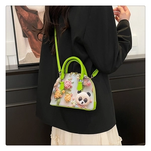 Detail view of 3D crochet floral and panda embroidery on shell-shaped handbag