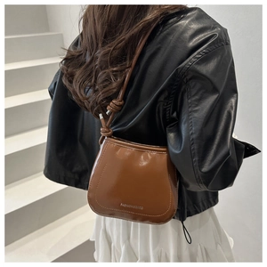 Brown patent leather shoulder bag with FASHION&BAGS silver logo and knotted strap detail