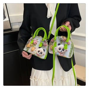 Detail of floral shell bag with 3D crochet flowers, panda motifs and green leather handles