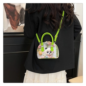 Detail of green floral shell bag with 3D panda embroidery and golden zipper hardware