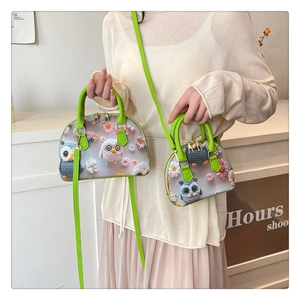 Detail of floral owl 3D embossed shell bags set with detachable green shoulder straps