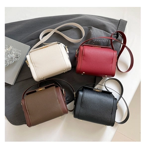 Detailed view of textured lychee grain leather mini box bags in four stylish colors