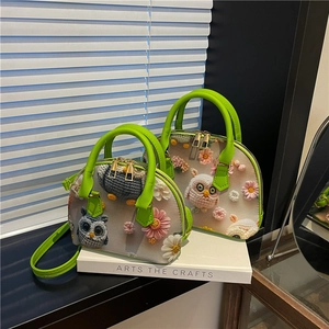 Detail of floral shell bag with 3D crochet owl and daisy embroidery on white leather