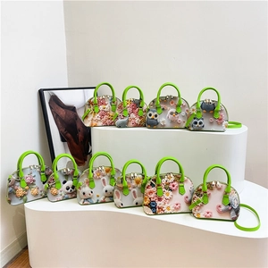 Floral 3D crochet shell bag with green faux leather straps and multiple animal patterns