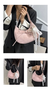 Detailansicht der rosa Knödeltasche mit Perlenspitzen-Charm und süßer Schleife