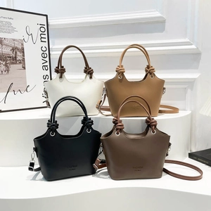 Retro trapezoidal bucket bag in four colors with knotted handles and adjustable shoulder strap