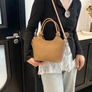 Vintage camel leather bucket bag with top handle and adjustable shoulder strap